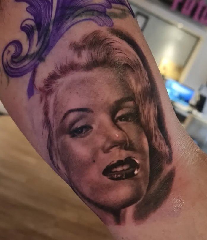 Realistic color portrait tattoo with purple accents